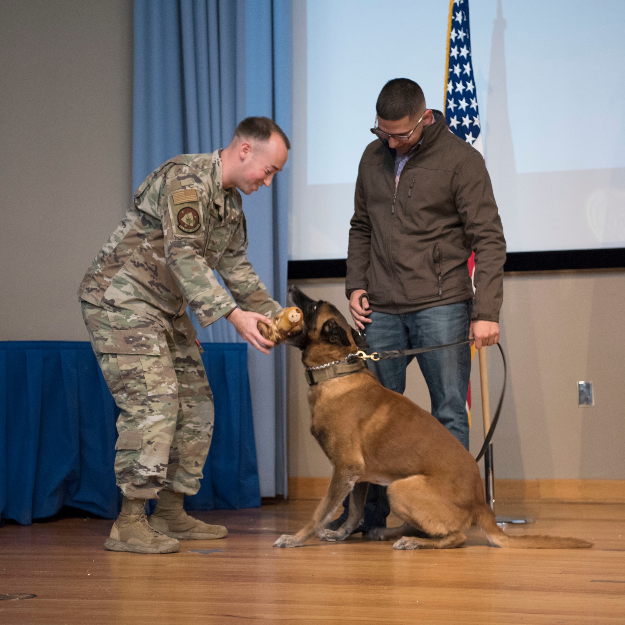 Staff Sgt. Nicholas Heckler, a 47th Security Forces Squadron military working dog trainer, gives MWD Cchico, a retired 47th SFS military working dog, his first bone Jan. 28, 2020, at Laughlin Air Force Base, Texas. U.S. Air Force military working dogs are given specific diets to promote healthy growth and ensure the dogs are toy-motivated, not treat-motivated. (U.S. Air Force photo by Senior Airman John A. Crawford)