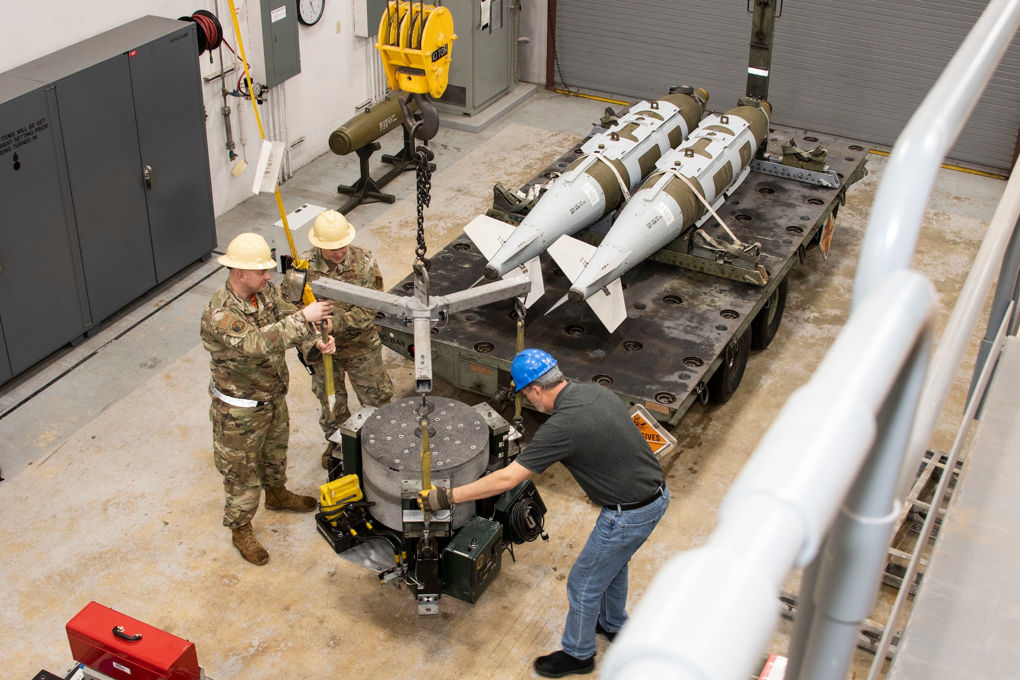 Photo of airmen preparing munitions.