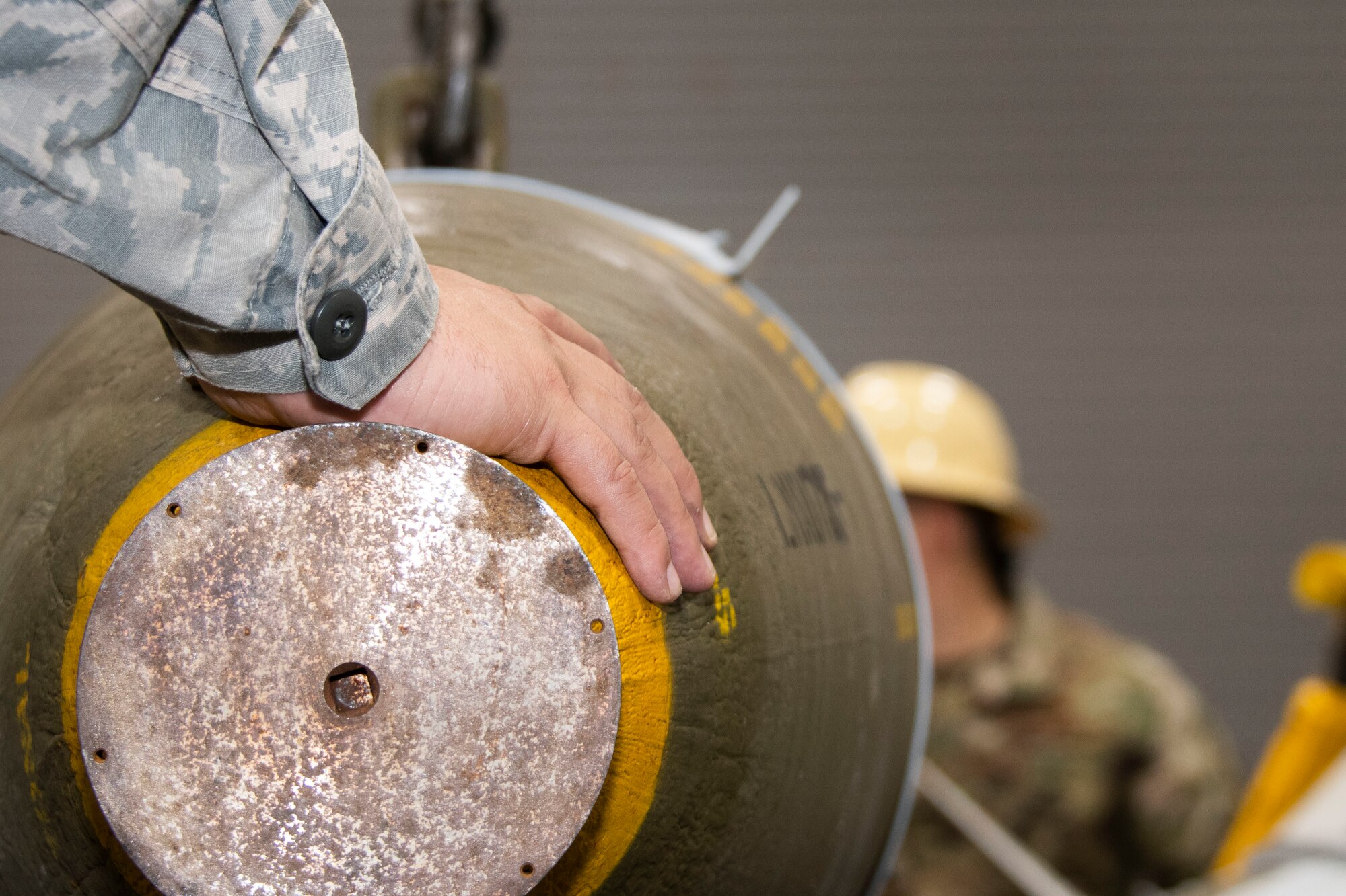 Photo of hand on bomb.