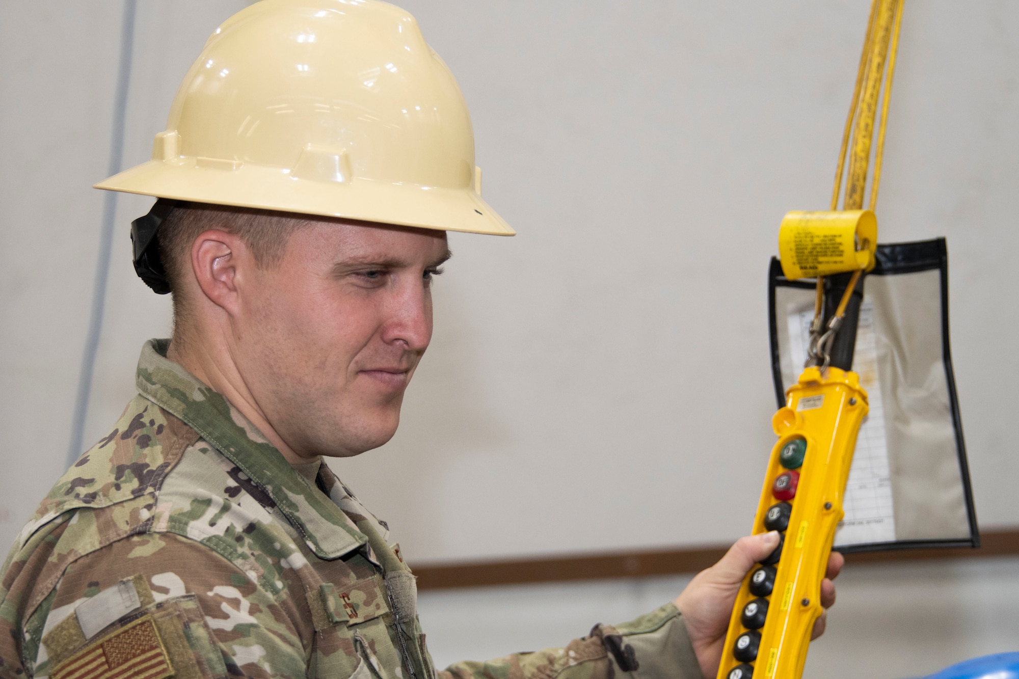 Photo of airman working hoist.