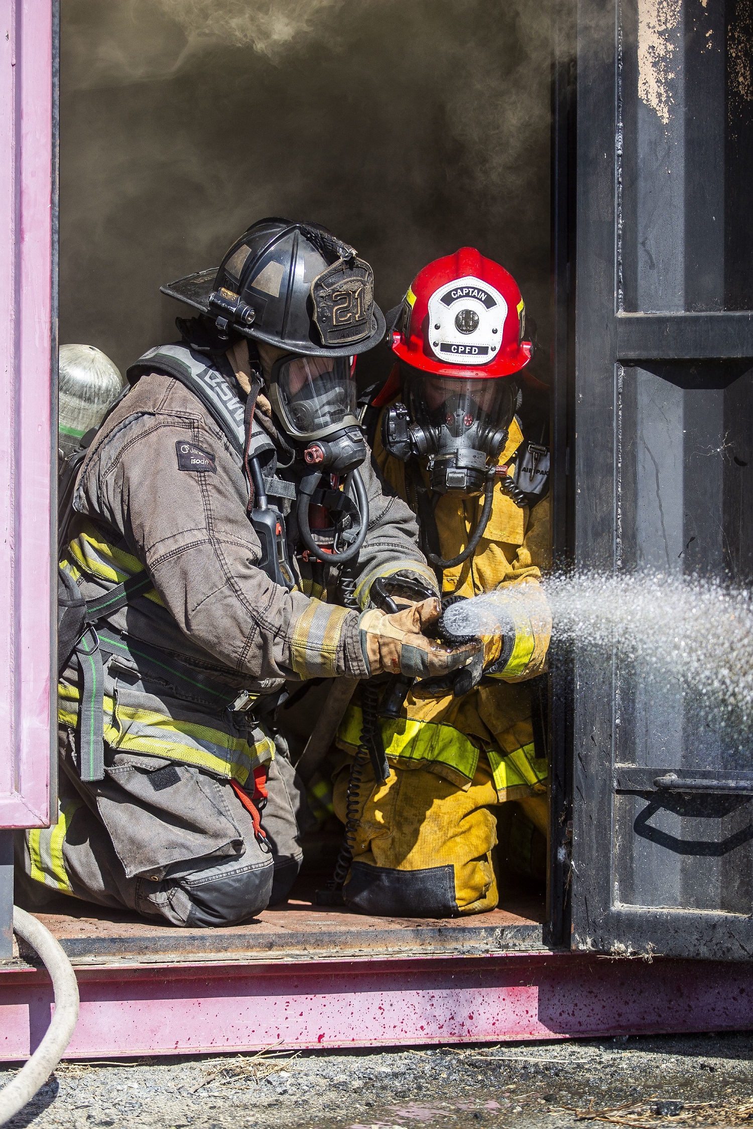 Dan Karrer, left, a firefighter paramedic with the Oceanside Fire Department, and Levi Randolph, a fire captain with the Camp Pendleton Fire Department, operate a fire hose during a joint structural firefighting exercise at Marine Corps Base Camp Pendleton, California, Jan. 28, 2020. The CPFD regularly hosts a variety of training exercises to strengthen their partnerships and cohesion with fire departments from surrounding communities in preparation for the annual wildfire season. (U.S. Marine Corps photo by Cpl. Dylan Chagnon)
