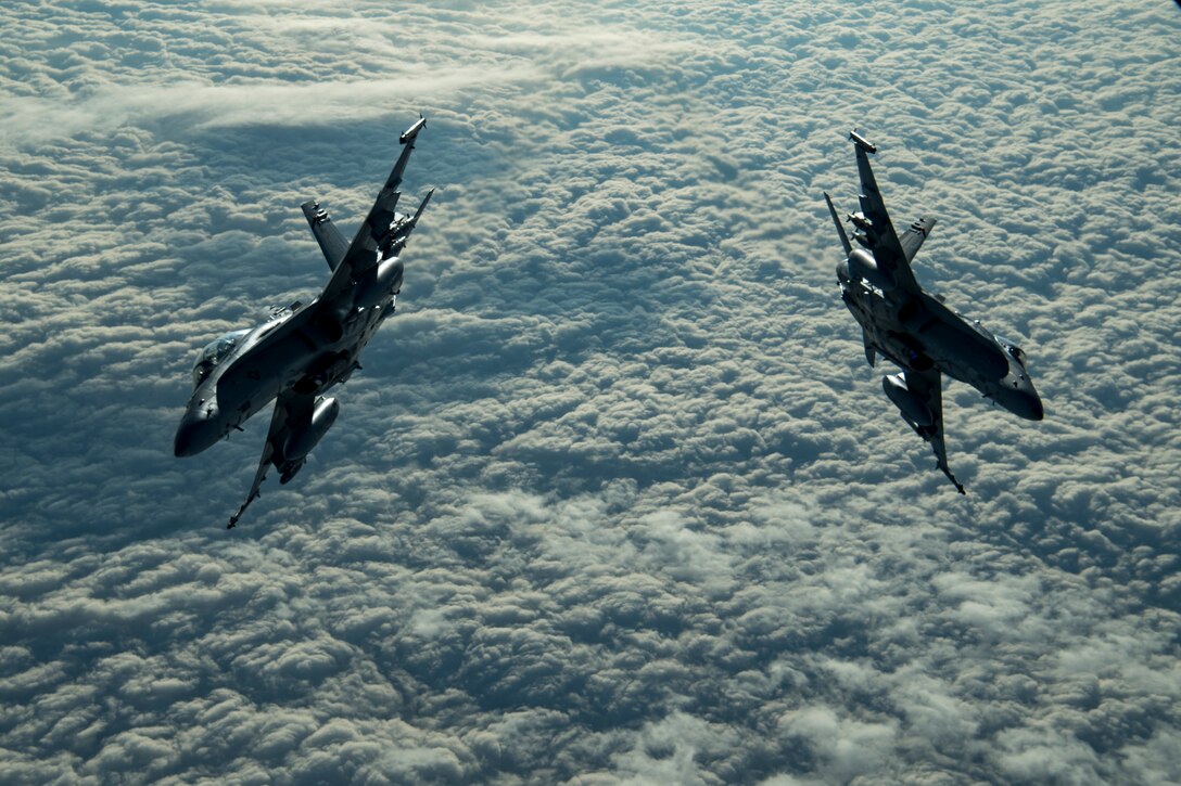 Two aircraft fly side by side.