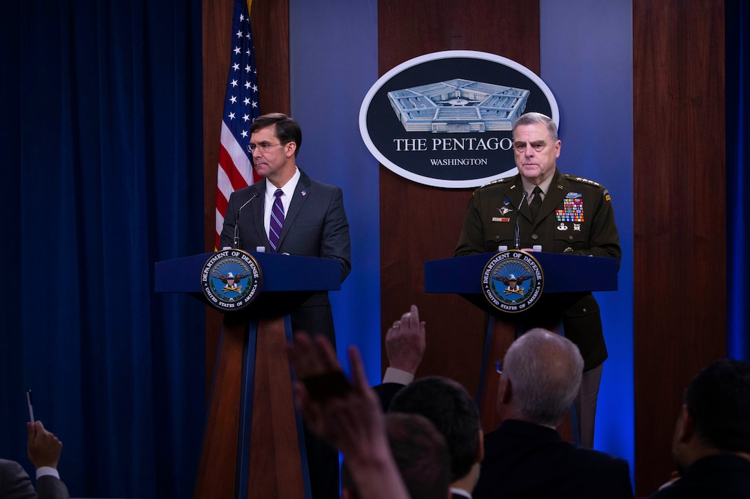 Defense Secretary Mark T. Esper and Chairman of the Joint Chiefs of Staff Army Gen. Mark A. Milley stand at a podium.