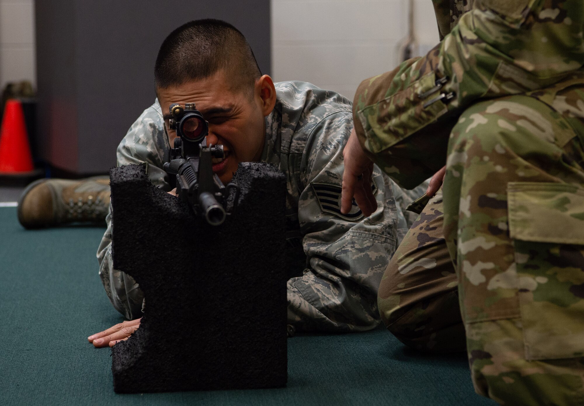 Staff Sgt. Dan Antonio Deladingco, 627th Security Forces Squadron (SFS) combat arms instructor, demonstrates the prone supported position to students during a qualification course for the M-4 rifle at Joint Base Lewis-McChord, Wash., Jan. 23, 2020. Combat arms is one of three missions for the 627th SFS, which also includes flight line security and protecting aircraft in austere environments through the Phoenix Raven program. (U.S. Air Force photo by Senior Airman Tryphena Mayhugh)