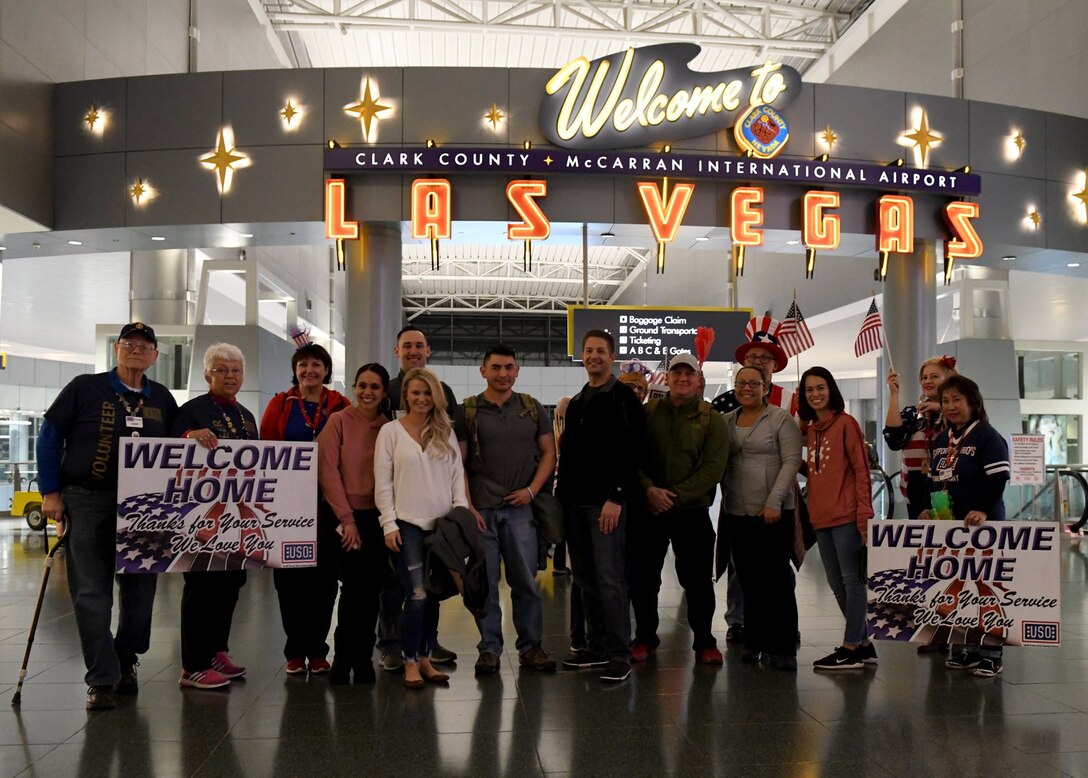 Returning 926th Force Support Squadron deployers, Master Sgt. Andrew Ueno and Tech. Sgt. Patrick Molitor, explosive ordnance disposal team, are greeted by members of the 926th WG and USO volunteers Jan. 14, 2020, at McCarran International Airport, Las Vegas, Nevada. (U.S. Air Force photo by Natalie Stanley)