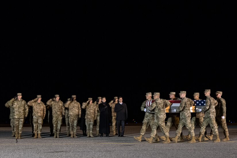 A U.S. Air Force carry team transfers the remains of Lt. Col. Paul K. Voss, of Yigo, Guam, during a dignified transfer Jan. 30, 2020, at Dover Air Force Base, Del. Voss was assigned to Headquarters Air Combat Command at Joint Base Langley-Eustis, Va. (U.S. Air Force photo by Roland Balik)