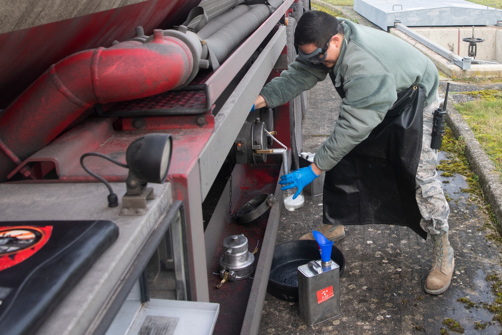 Staff Sgt. Manuel Cienfuegos, 100th Logistics Readiness Squadron noncommissioned officer in charge of fuels laboratory, collects a sample of Jet Propellant 8 fuel Jan. 27, 2020, at RAF Mildenhall, England. Members of the 100th LRS fuel management flight perform quality assurance checks on the fuel to make sure only high quality gas is being put into aircraft, ensuring mission readiness. (U.S. Air Force photo by Airman 1st Class Joseph Barron)