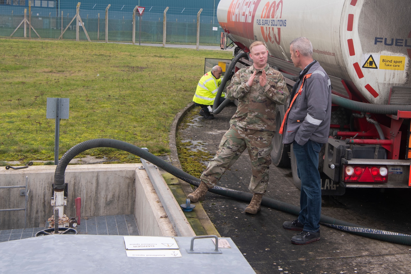 Master Sgt. Joseph Feiss, 100th Logistics Readiness Squadron noncommissioned officer in charge of fuels environmental safety office, and Mike Wilson, Defense Logistics Agency quality assurance representative, discuss the fuel transfer process Jan. 27, 2020, at RAF Mildenhall, England. The 100th LRS fuel management flight proved their mission readiness by obtaining fuel through a tanker truck instead of underground pipes. (U.S. Air Force photo by Airman 1st Class Joseph Barron)