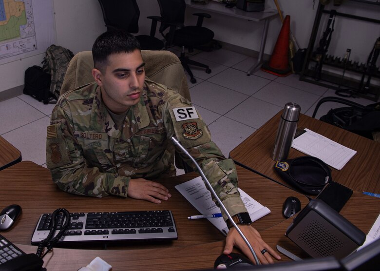 Staff Sgt. Mark Soltero, 627th Security Forces Squadron base defense operations center (BDOC) controller, responds to a transmission pertaining to flight line security at Joint Base Lewis-McChord, Wash., Dec. 4, 2019. Soltero and other BDOC Airmen monitor communications and video surveillance to make sure the flight line on McChord Field is secure. (U.S. Air Force photo by Senior Airman Tryphena Mayhugh)