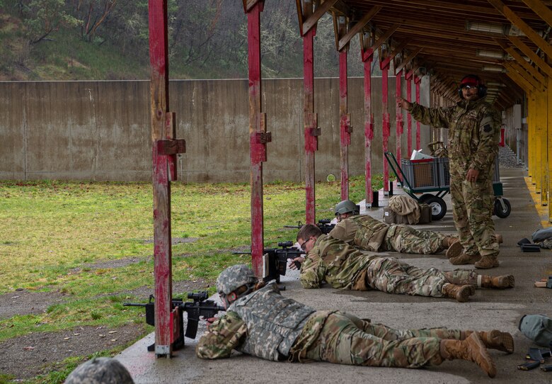 Staff Sgt. Louis Lira, 627th Security Forces Squadron combat arms instructor, indicates that his side of the firing range is clear during a qualification course at Joint Base Lewis-McChord, Wash., Jan. 23, 2020. Lira and other combat arms instructors taught the students how to position, load, chamber and clear malfunctions for M-4 rifles during the course. (U.S. Air Force photo by Senior Airman Tryphena Mayhugh)