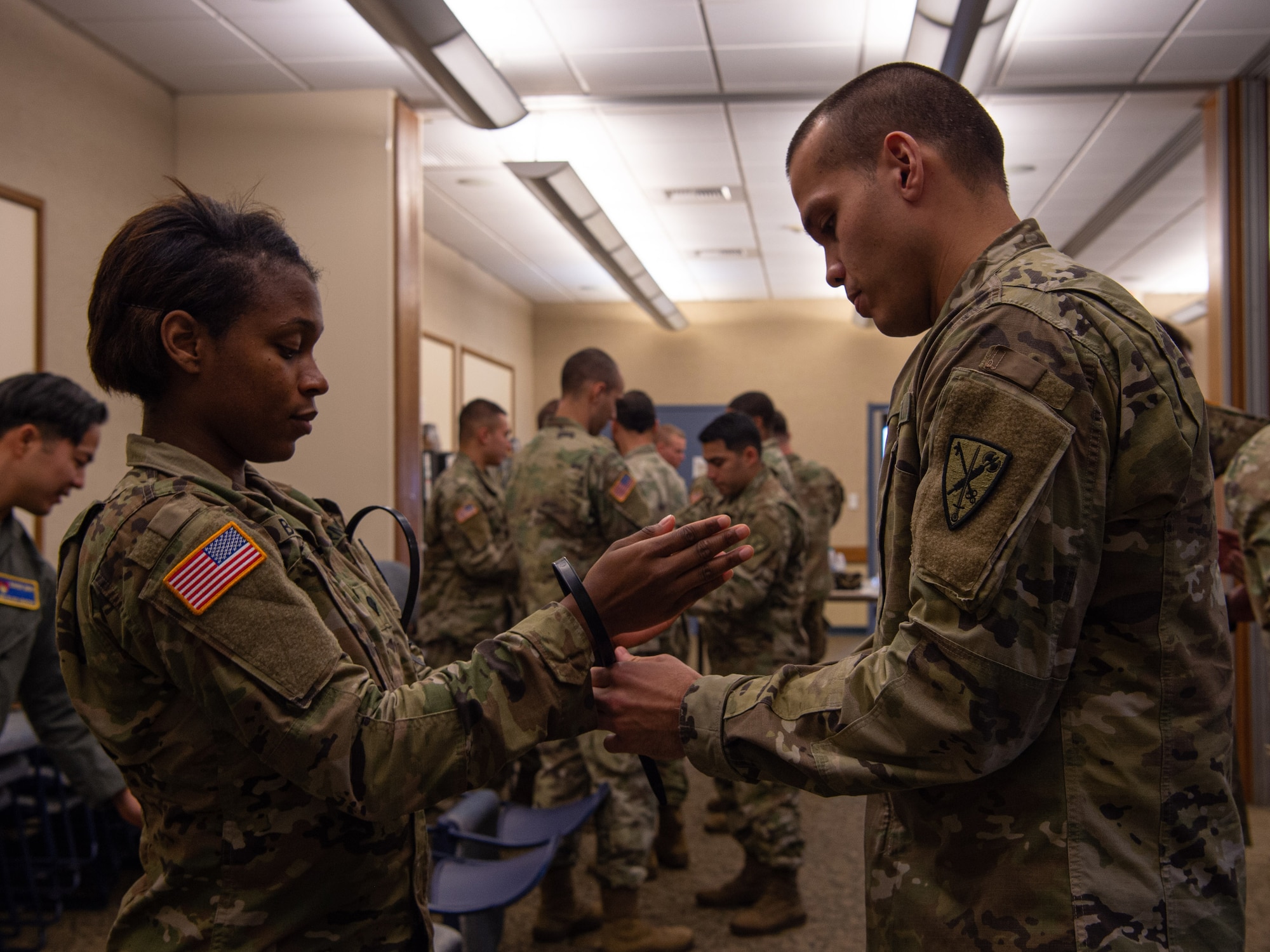 A student of the 627th Security Forces Squadron Phoenix Raven’s instruction course for how to properly process and hold detainees practices handcuffing a simulated detainee at Joint Base Lewis-McChord, Wash., Dec. 5, 2019. The course taught Soldiers assigned to the 595th Military Police Company, 508th Military Police Battalion, how to handcuff, search and move detainees in a safe manner. (U.S. Air Force photo by Senior Airman Tryphena Mayhugh)