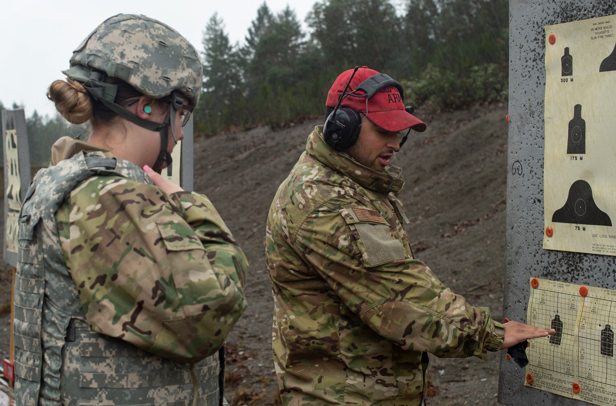 Staff Sgt. Louis Lira, 627th Security Forces Squadron combat arms instructor, right, advises a student about what adjustments they should make to their M-4 rifle during a qualification course at Joint Base Lewis-McChord, Wash., Jan. 23, 2020. Students of course were required to pass the qualification in order to deploy or move to another base. (U.S. Air Force photo by Senior Airman Tryphena Mayhugh)