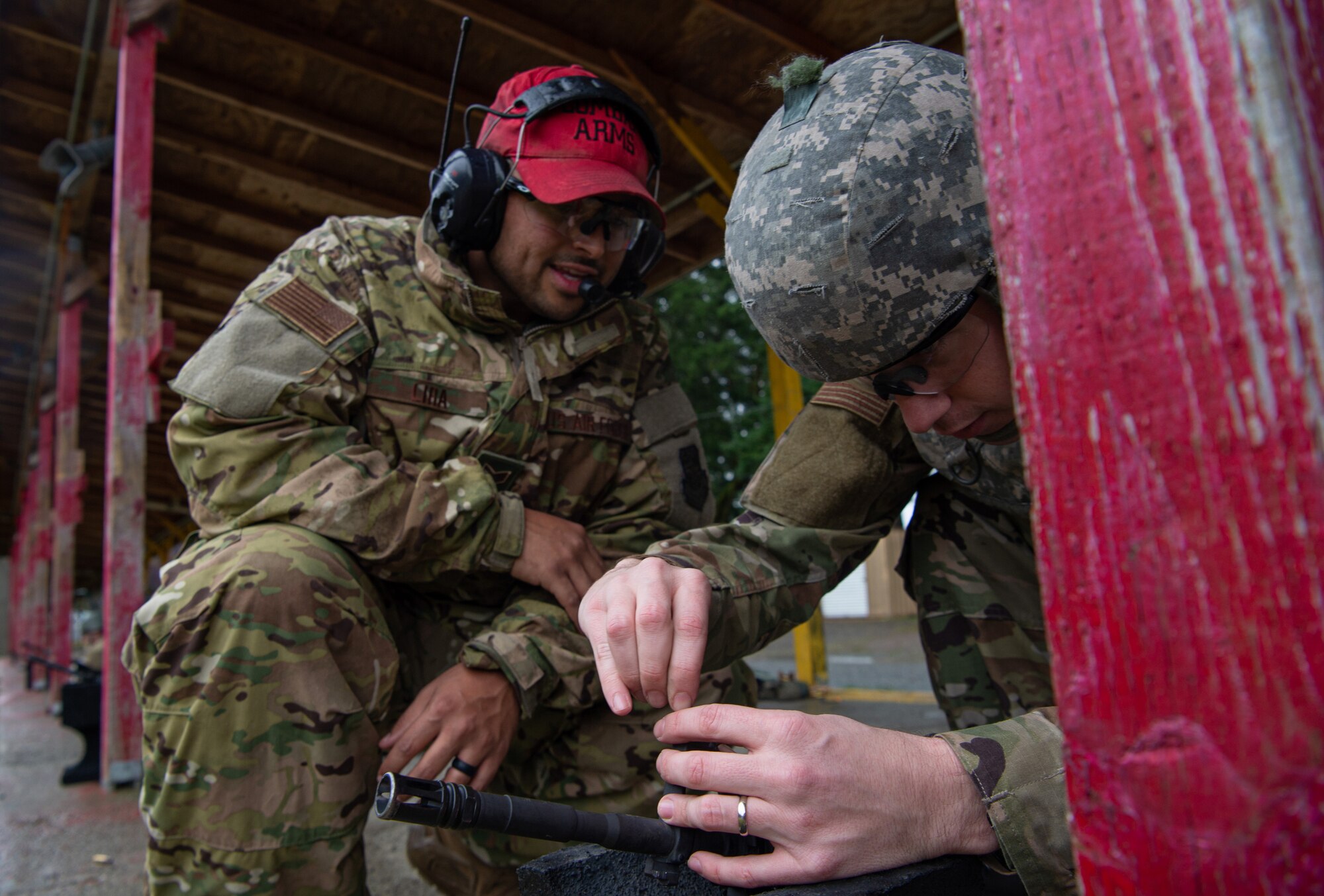 Staff Sgt. Louis Lira, 627th Security Forces Squadron combat arms instructor, watches a student adjust the sights on their M-4 rifle during a qualification course at Joint Base Lewis-McChord, Wash., Jan. 23, 2020. The students spent the first half of the class learning the fundamentals for firing the rifle, and the latter half qualifying on the weapon at a range. (U.S. Air Force photo by Senior Airman Tryphena Mayhugh)