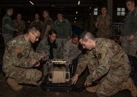 Airmen from the 35th Fighter Wing disassemble a communication flyaway kit at Misawa Air Base, Japan, Jan. 29, 2020. The CFK is a network used to connect to a satellite to help provide people with communications wherever they are. Multi-Domain Airman training encompasses the necessary skills, knowledge and experience to successfully generate combat power in an austere and expeditionary battlespace. (U.S. Air Force photo by Airman 1st Class China M. Shock)