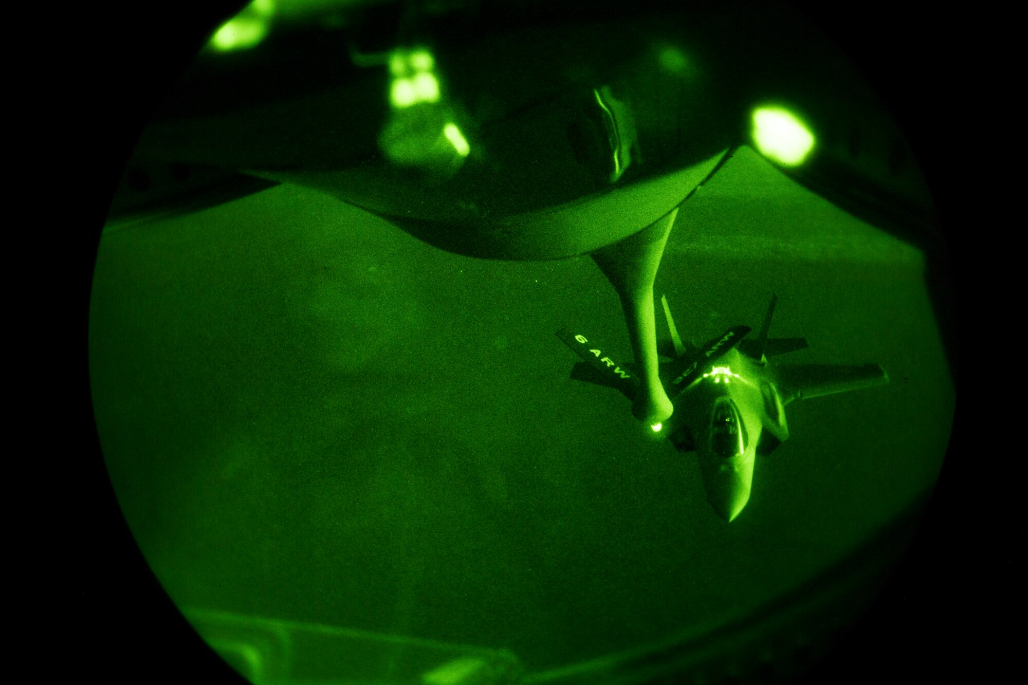 (A U.S. Air Force F-35A Lightning II assigned to the 34th Expeditionary Fighter Squadron approaches a U.S. Air Force KC-135 Stratotanker assigned to the 28th Expeditionary Air Refueling Squadron to conduct an aerial refueling in the U.S. Central Command area of operation, Jan. 3, 2020.