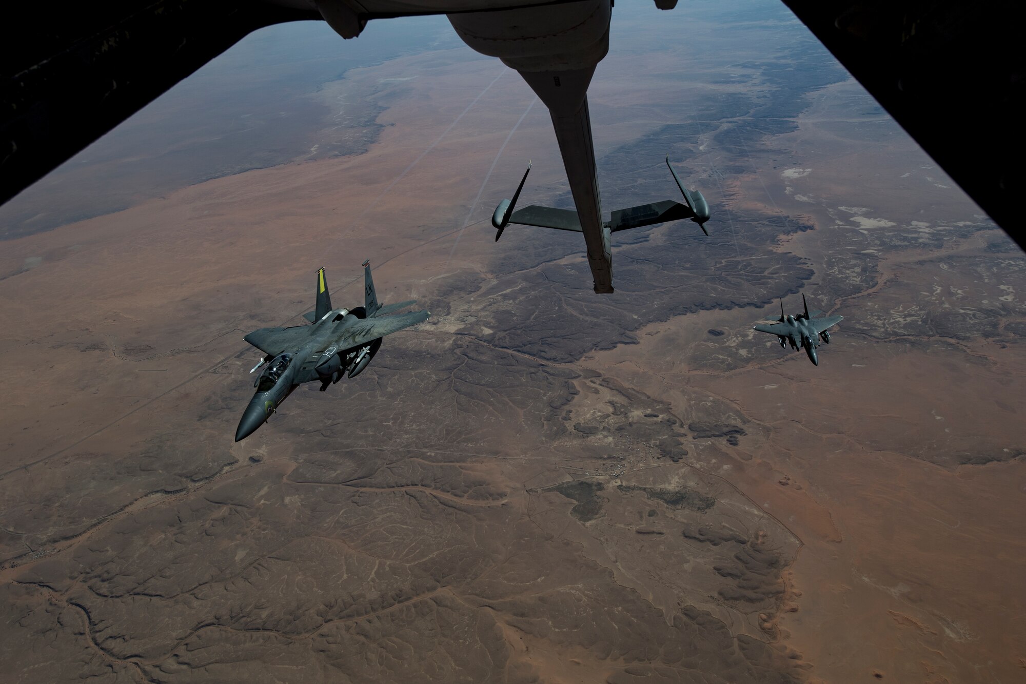 Two U.S. Air Force F-15E Strike Eagles assigned to the 494th Expeditionary Fighter Squadron fly behind a U.S. Air Force KC-10 Extender assigned to the 908th Expeditionary Air Refueling Squadron above the U.S. Central Command area of responsibility, Jan. 15, 2020.