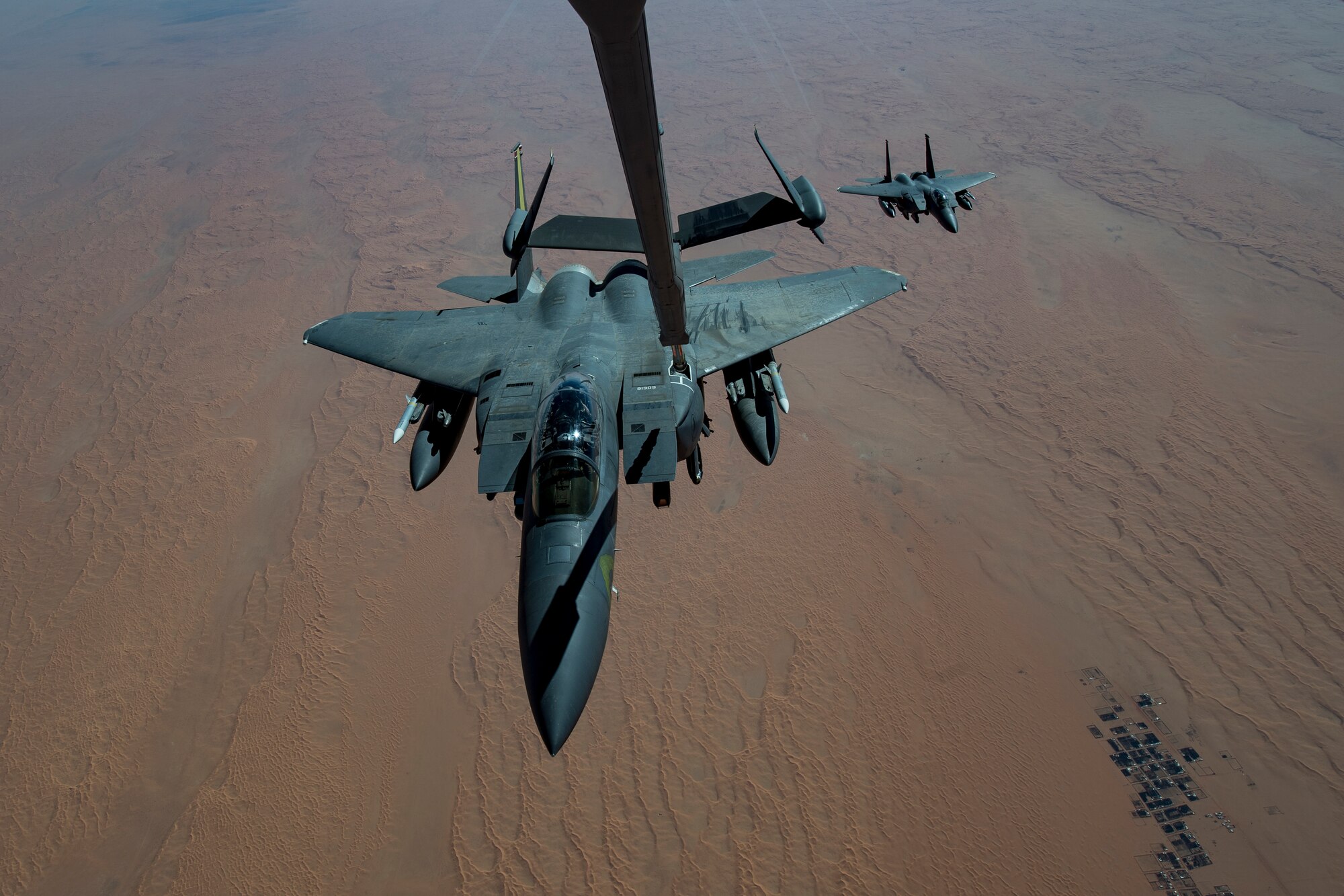 A U.S. Air Force F-15E Strike Eagle assigned to the 494th Expeditionary Fighter Squadron receives fuel from a U.S. Air Force KC-10 Extender assigned to the 908th Expeditionary Air Refueling Squadron above the U.S. Central Command area of responsibility, Jan. 15, 2020.
