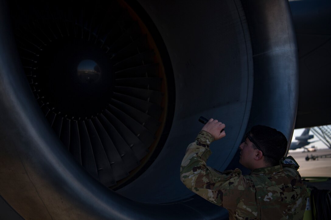 A U.S. Air Force flight engineer assigned to the 908th Expeditionary Air Refueling Squadron conducts preflight checks on a KC-10 Extender at Al Dhafra Air Base, United Arab Emirates Jan. 17, 2020.
