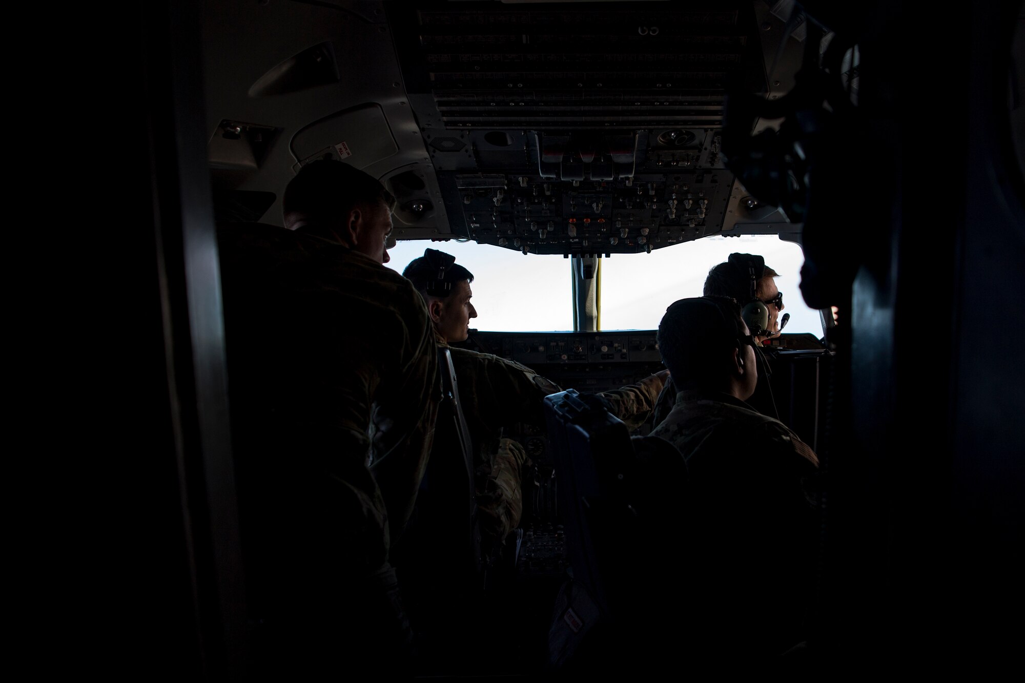 U.S. Air Force aircrew members look out the window of a U.S. Air Force KC-10 Extender, assigned to the 908th Expeditionary Air Refueling Squadron above the U.S. Central Command area of responsibility, Jan. 17, 2020.
