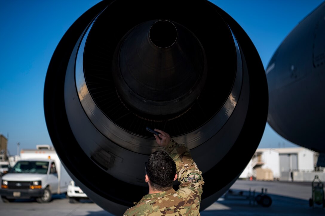A U.S. Air Force flight engineer assigned to the 908th Expeditionary Air Refueling Squadron conducts preflight checks on a KC-10 Extender at Al Dhafra Air Base, United Arab Emirates Jan. 17, 2020.