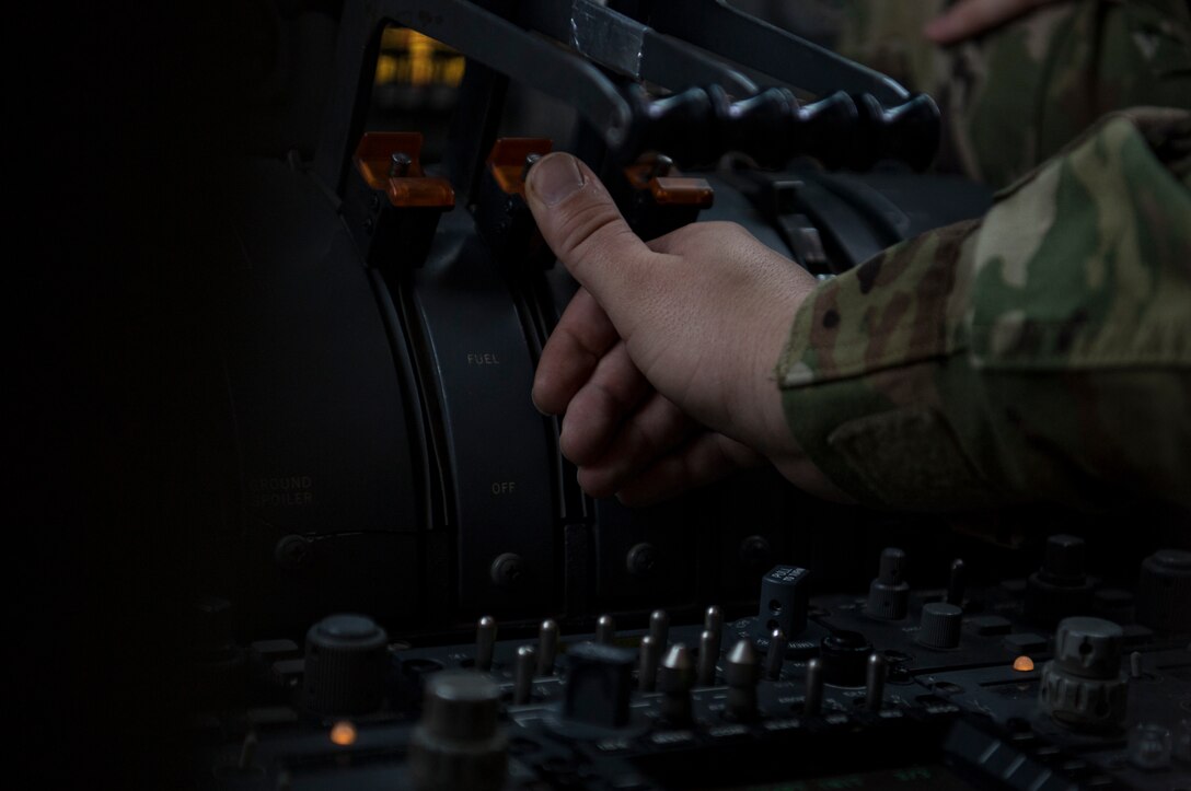 A U.S. Air Force flight engineer assigned to the 908th Expeditionary Air Refueling Squadron adjusts aircraft settings onboard a U.S. Air Force KC-10 Extender at Al Dhafra Air Base, United Arab Emirates Jan. 17, 2020.