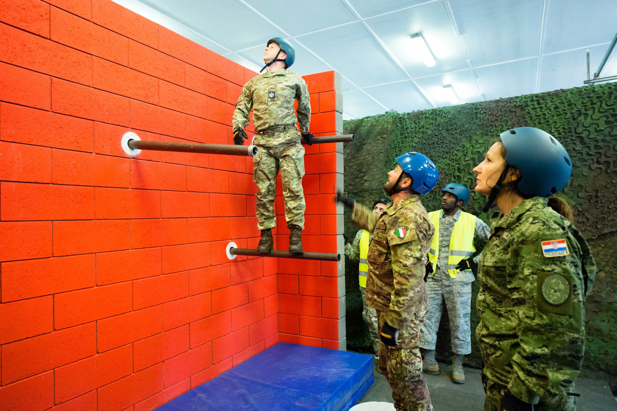Flight Sgt. Mark Moore, Royal Air Force (left) participates in a leadership reaction course task while attending the Inter-European Noncommissioned Officer Academy at Kapaun Air Station, Germany, Nov. 6, 2019. Flight Sgt. Moore is one of two first time students from the United Kingdom to attend this course. Two courses, the Inter-European Squadron Officer School and Noncommissioned Officer Academy were attended by 44 officers and enlisted from 21 different countries. (Courtesy Photo)
