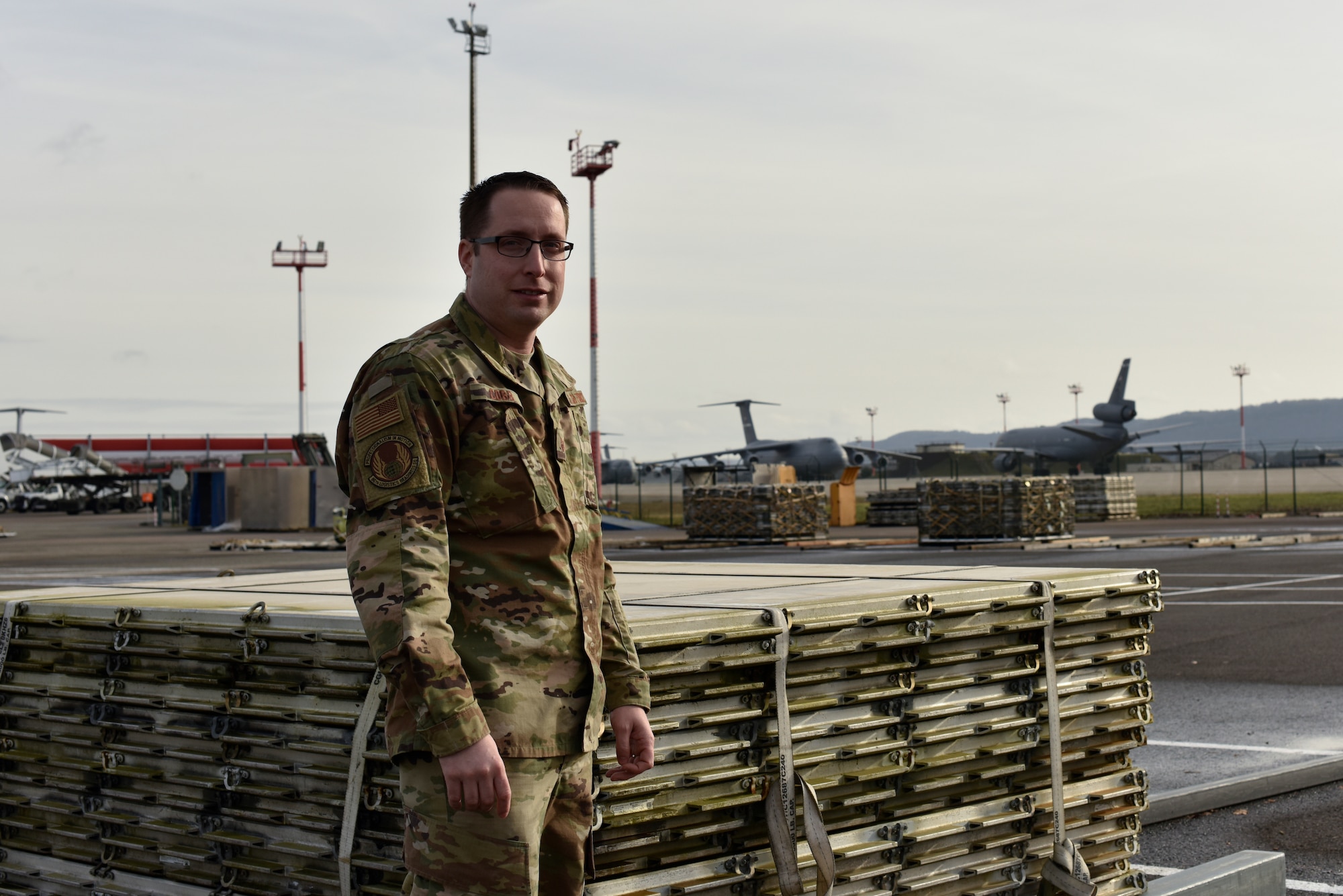 U.S. Air Force Tech. Sgt. Tyler J. Cobb, 86th Logistics Readiness Squadron cargo deployment function and air passenger terminal section chief, stands in front of a palette at Ramstein Air Base, Germany, Jan. 30, 2020.
