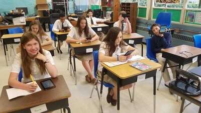 Eight graders at Alleluia Community School in Augusta, Georgia, try out their math skills using a new application on the Kindle Fire devices their school recently received through the Defense Logistics Agency.
