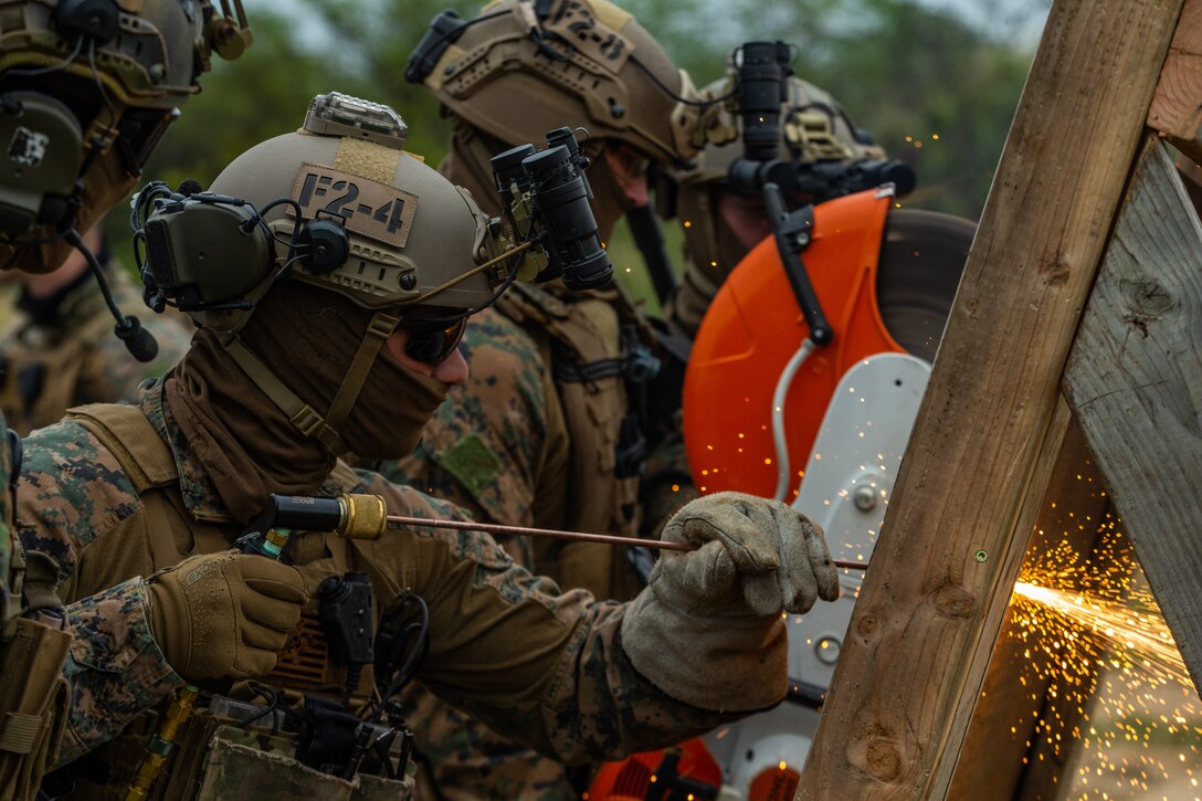 U.S. Marines breach a simulated entrance during Visit, Board, Search and Seizure training in Iroquois Point, Hawaii, Jan. 13.
