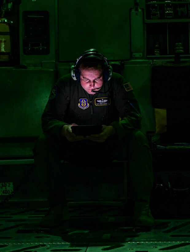 Tech. Sgt. Drew Czarnecki, 758th Airlift Squadron loadmaster, reads a technical order during a training sortie over Ohio, Jan. 16, 2020. Technical orders describe different steps for a variety of job functions loadmasters must perform to complete their tasks