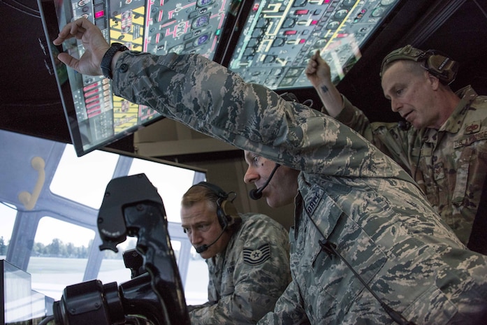 Dedicated crew chiefs, U.S. Air Force Tech Sgts Chris Hamilton, Steve Lawrence, and Mark Gede go over engine run procedures.