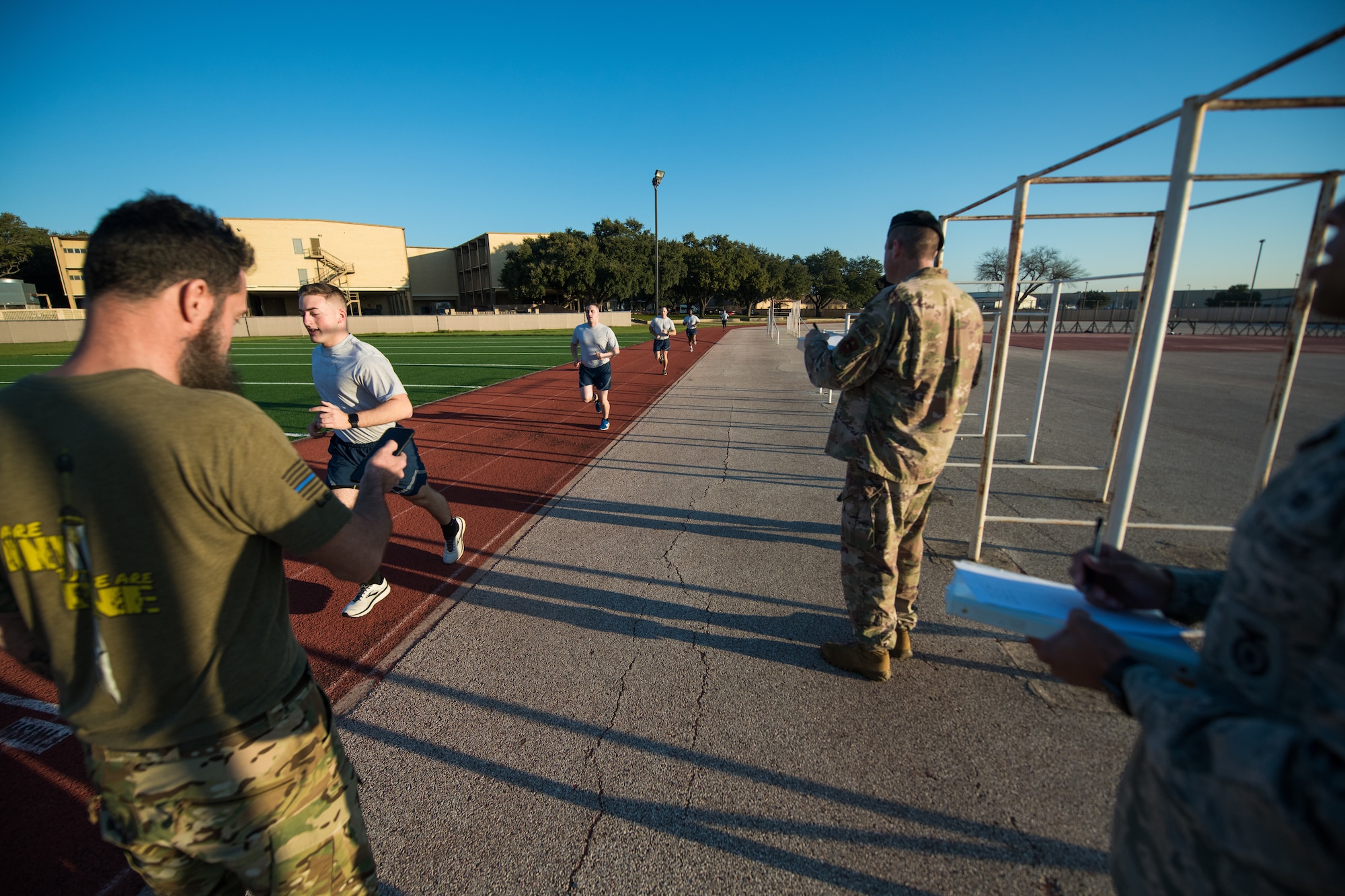 U.S. Air Force Security Forces Airmen take part in the run portion of a physical fitness test as the opening day of the Air Education and Training Command Defender Challenge team tryout at Joint Base San Antonio-Lackland, Texas, Jan. 27, 2020. The five-day selection camp includes a physical fitness test, M-9 and M-4 weapons firing, the alpha warrior obstacle course, a ruck march and also includes a military working dog tryout as well. A total of 27 Airmen, including five MWD handlers and their canine partners, were invited to tryout for the team. The seven selectees to the AETC team will represent the First Command at the career field’s world-wide competition that will be held at JBSA-Camp Bullis in May 2020. (U.S. Air Force photo by Sarayuth Pinthong)