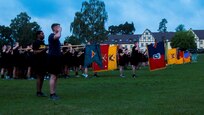 Soldiers from 7th Army Training Command (7 ATC) presents arms for the raising of the flag during a Jäger Run in Grafenwoehr, Germany, August 16, 2019. Brig. Gen. Christopher Norrie led the Jäger Run with representatives from 7 ATC’s brigades and directorates present to promote unit cohesion and strengthen esprit de corps.