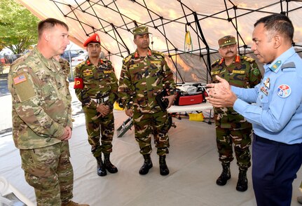 Oregon Army National Guard Sgt. Aaron Stiner, left, leads a discussion with members of the Bangladesh military touring the Portland Air National Guard Base, Ore., Sept. 27, 2017, as part of the State Partnership Program (SPP) between Oregon and the Bangladesh military.