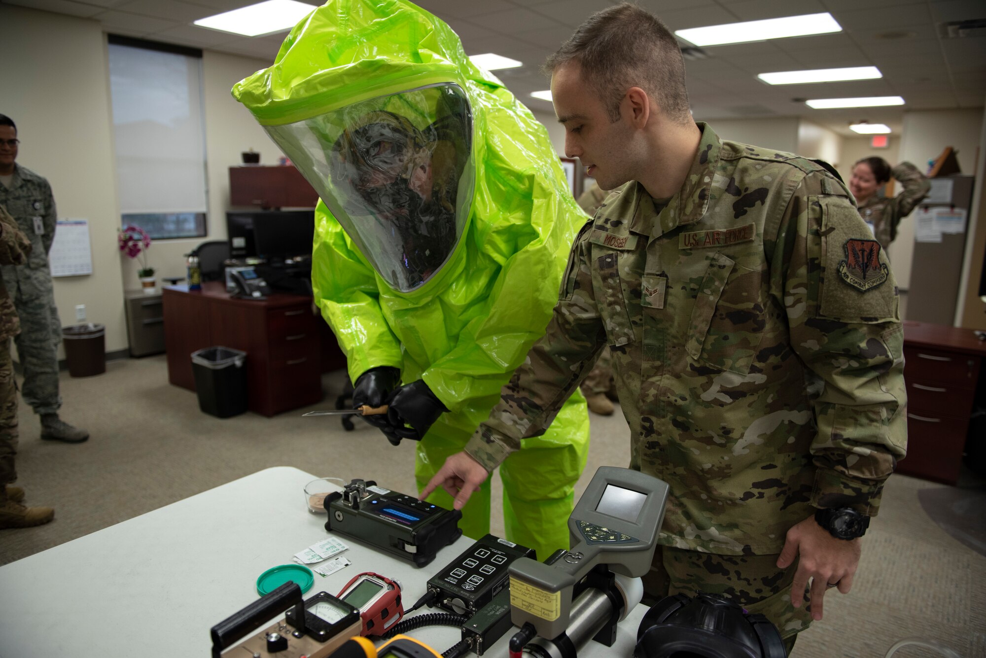 A photo of an Airman showing leadership how a HazMatID Elite machine works during an immersion tour.