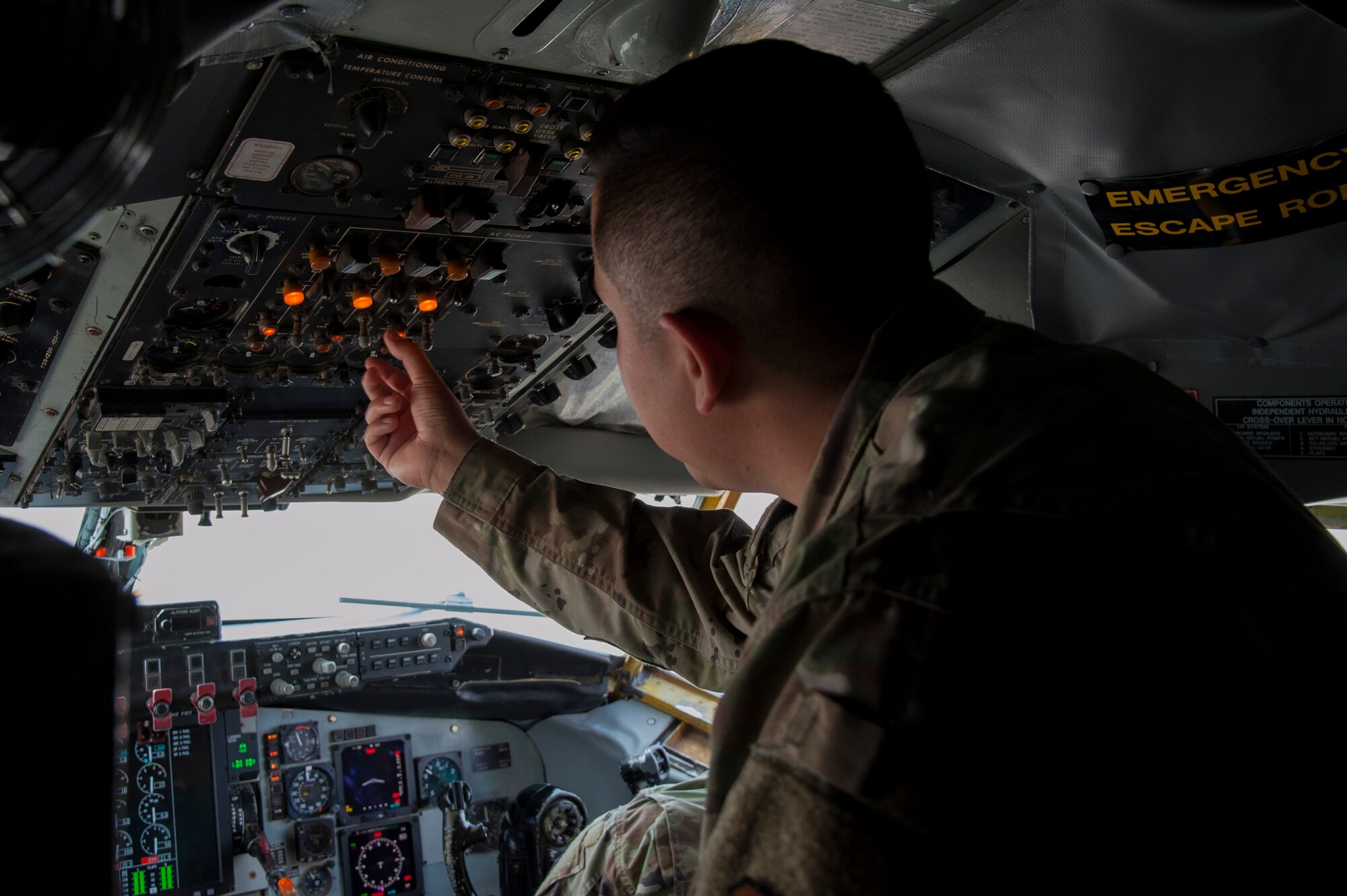 U.S. Air Force Senior Airman Eric Flores, a 6th Aircraft Maintenance Squadron electrical and environmental systems journeyman, changes a lightbulb on the overhead control panel of a KC-135 Stratotanker, Jan. 23, 2020, at MacDill Air Force Base, Fla.  Electrical and environmental systems Airmen are responsible for maintaining and repairing aircraft wiring and electrical components.