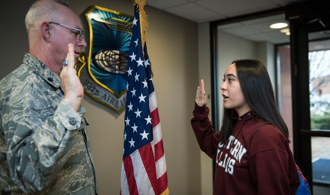 Janice Williams recites the oath of enlistment given to her on Jan. 30, 2020 by Lt. Col. Stan Paregien, 932nd Airlift Wing Public Affairs Officer, during a reenlistment ceremony at the 932nd AW Headquarters building, Scott Air Force Base, Illinois. Williams will start her Air Force adventure as a crew chief soon, and will join her brother, Senior Airman Jacob Williams, here in the 932nd Maintenance Squadron. “This is something I never thought possible,” said Williams about the opportunity to work with her brother while serving in the Air Force Reserve. (U.S. Air Force photo by Christopher Parr)
