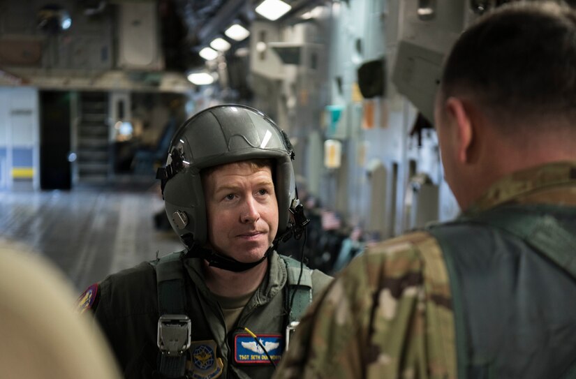 Tech. Sgt. Seth Dunworth, 15th Airlift Squadron loadmaster, prepares to deploy illumination flares and position markers aboard a C-17 Globemaster III during Air Mobility Command Test and Evaluation Squadron’s assessment of tactics, techniques and procedures for astronaut rescue and recovery efforts Jan. 22, 2020, at Patrick Air Force Base, Fla.