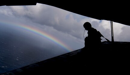 Master Sgt. Randall Yamada, a loadmaster with the 204th Airlift Squadron, sits on the ramp of a C-17 Globemaster III from Joint Base Charleston during Air Mobility Command Test and Evaluation Squadron’s assessment of tactics, techniques and procedures for astronaut rescue and recovery efforts Jan. 22, 2020, off the coast of Florida, near Patrick Air Force Base, Fla.