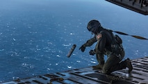 Master Sgt. Randall Yamada, a loadmaster with the 204th Airlift Squadron, deploys a position marker from the ramp of a C-17 Globemaster III from Joint Base Charleston during Air Mobility Command Test and Evaluation Squadron’s assessment of tactics, techniques and procedures for astronaut rescue and recovery efforts Jan. 22, 2020, off the coast of Florida near Patrick Air Force Base.