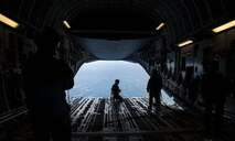 Master Sgt. Cecil Dickerson, a loadmaster with the 144th Airlift Squadron, prepares to deploy illumination flares and position markers from the ramp of a C-17 Globemaster III from Joint Base Charleston during Air Mobility Command Test and Evaluation Squadron’s assessment of tactics, techniques and procedures for astronaut rescue and recovery efforts Jan. 22, 2020, off the coast of Florida near Patrick Air Force Base.