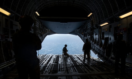 Master Sgt. Cecil Dickerson, a loadmaster with the 144th Airlift Squadron, prepares to deploy illumination flares and position markers from the ramp of a C-17 Globemaster III from Joint Base Charleston during Air Mobility Command Test and Evaluation Squadron’s assessment of tactics, techniques and procedures for astronaut rescue and recovery efforts Jan. 22, 2020, off the coast of Florida near Patrick Air Force Base.