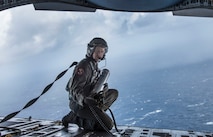 Tech. Sgt. Seth Dunworth, 15th Airlift Squadron loadmaster, prepares to deploy an illumination flare from the ramp of the aircraft during Air Mobility Command Test and Evaluation Squadron’s assessment of tactics, techniques and procedures for astronaut rescue and recovery efforts Jan. 22, 2020, off the coast of Florida near Patrick Air Force Base
