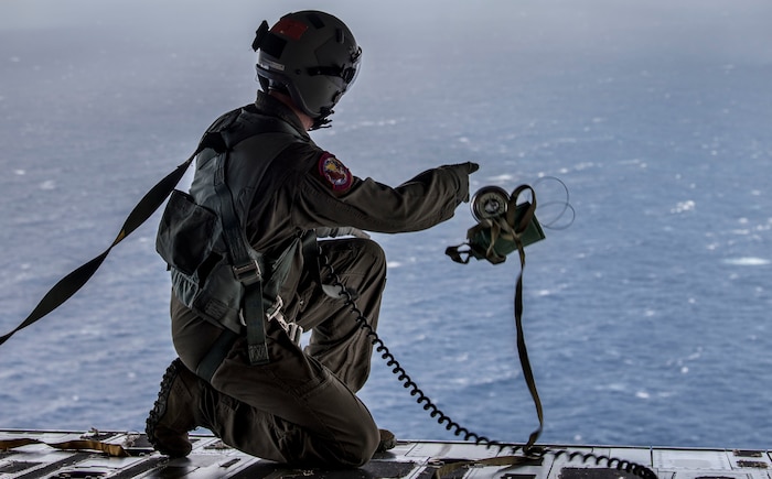 Tech. Sgt. Seth Dunworth, 15th Airlift Squadron loadmaster, deploys an illumination flare from the ramp of the aircraft during Air Mobility Command Test and Evaluation Squadron’s assessment of tactics, techniques and procedures for astronaut rescue and recovery efforts Jan. 22, 2020, off the coast of Florida near Patrick Air Force Base.