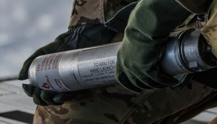 Tech. Sgt. Anthony Patton, 15th Airlift Squadron loadmaster, prepares to deploy an illumination flare from the ramp of the aircraft during  Air Mobility Command Test and Evaluation Squadron’s assessment of tactics, techniques and procedures for astronaut rescue and recovery efforts Jan. 22, 2020, off the coast of Florida near Patrick Air Force Base.