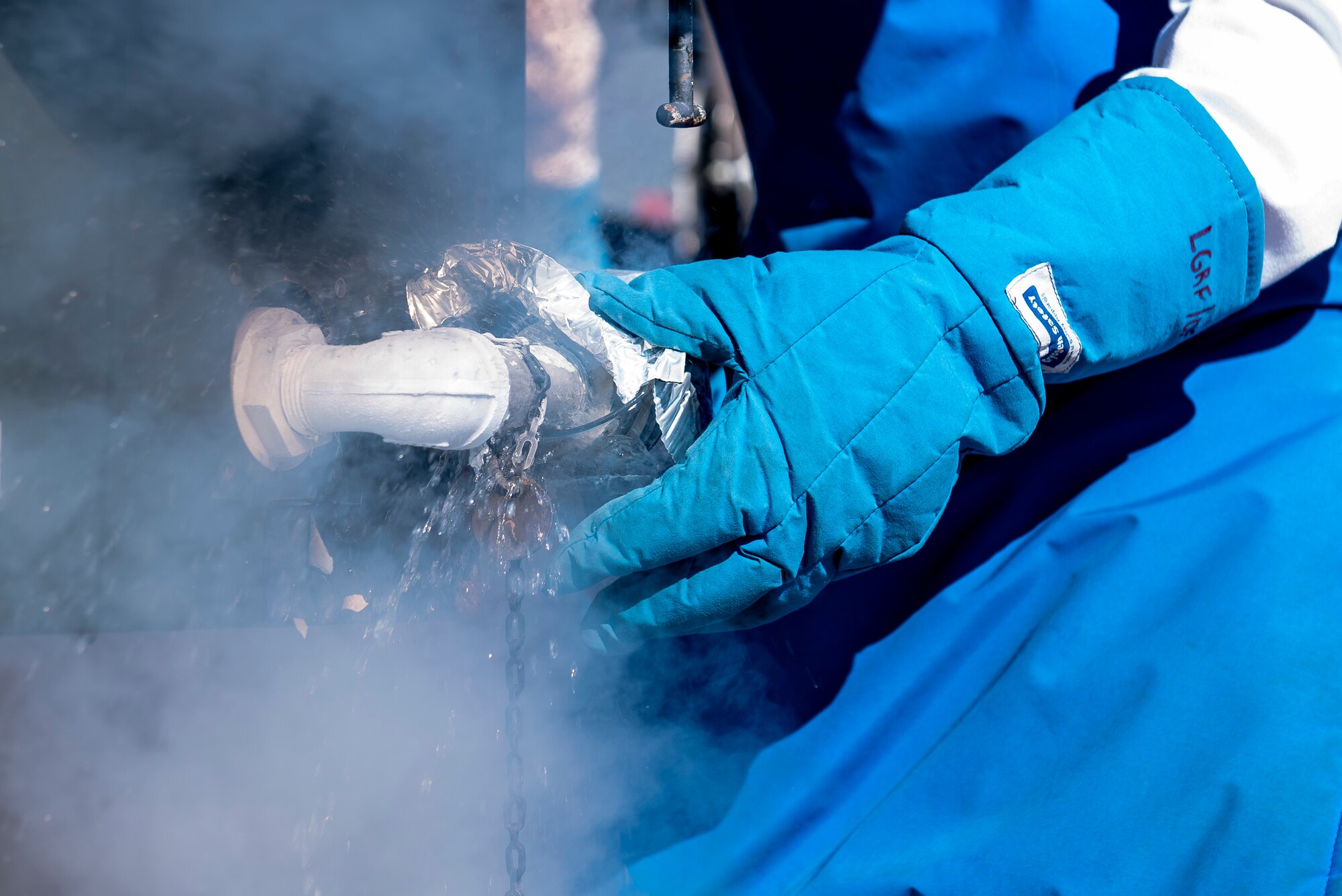 Airman 1st Class Daniel Sage, 27th Special Operations Logistics Readiness Squadron fuels facilities technician, collects a sample of liquid oxygen while filling a tank at Cannon Air Force Base, New Mexico, Jan. 30, 2020. To ensure the safety of those breathing the oxygen, tests are run to ensure the oxygen maintains 99.5% purity. (U.S. Air Force photo by Senior Airman Vernon R. Walter III)