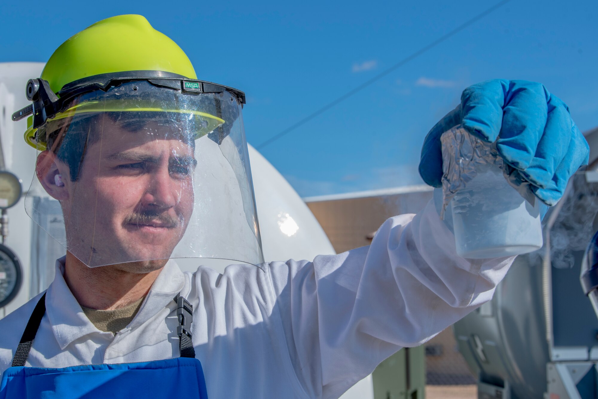 Airman 1st Class Daniel Sage, 27th Special Operations Logistics Readiness Squadron fuels facilities technician, checks a liquid oxygen sample for any contaminants at Cannon Air Force Base, New Mexico, Jan. 30, 2020. The use of liquid oxygen on aircraft prevents the aircrew and pilots from experiencing illnesses such as altitude sickness and hypoxia. (U.S. Air Force photo by Senior Airman Vernon R. Walter III)