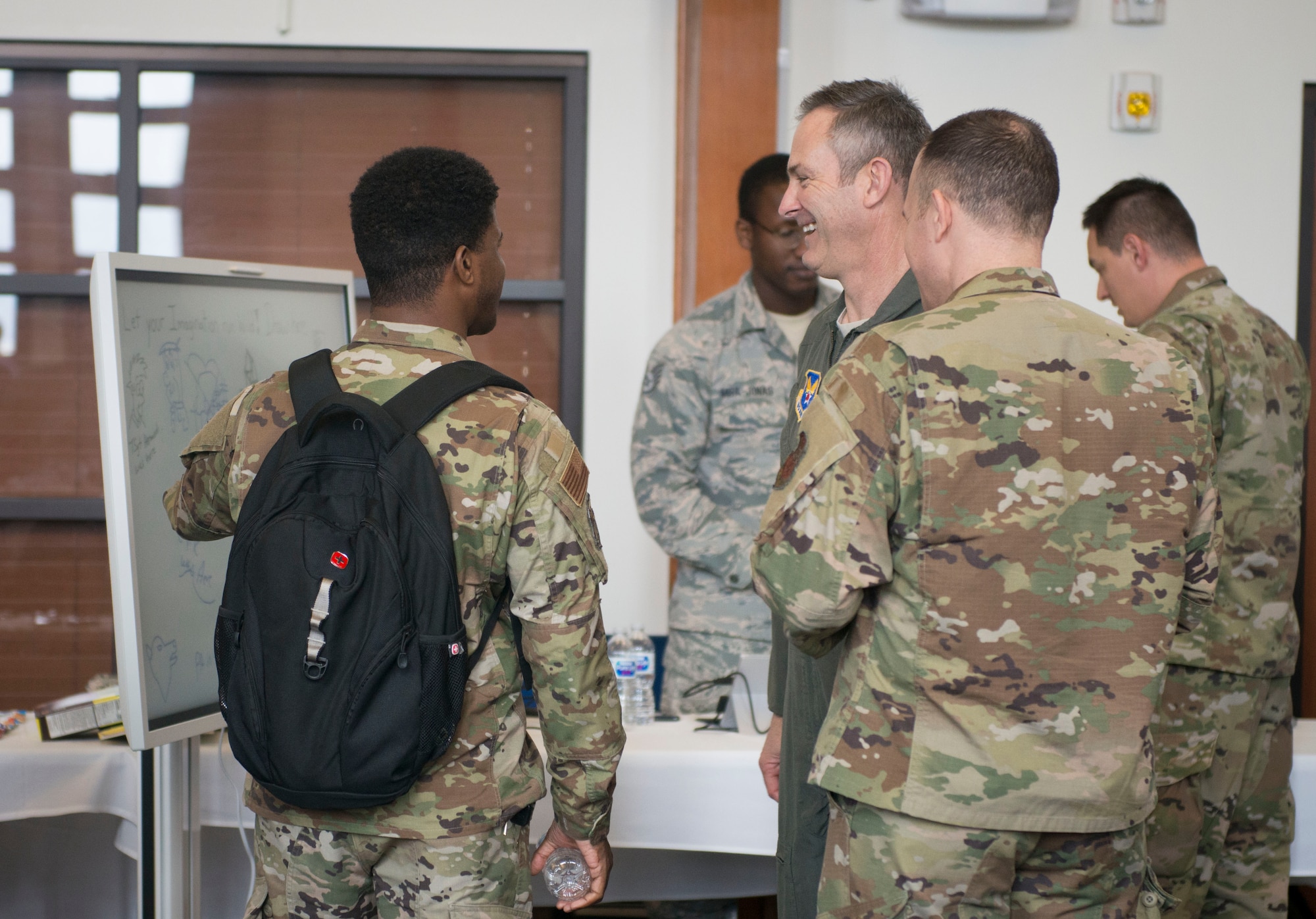 A photograph of uniformed members talking about innovation