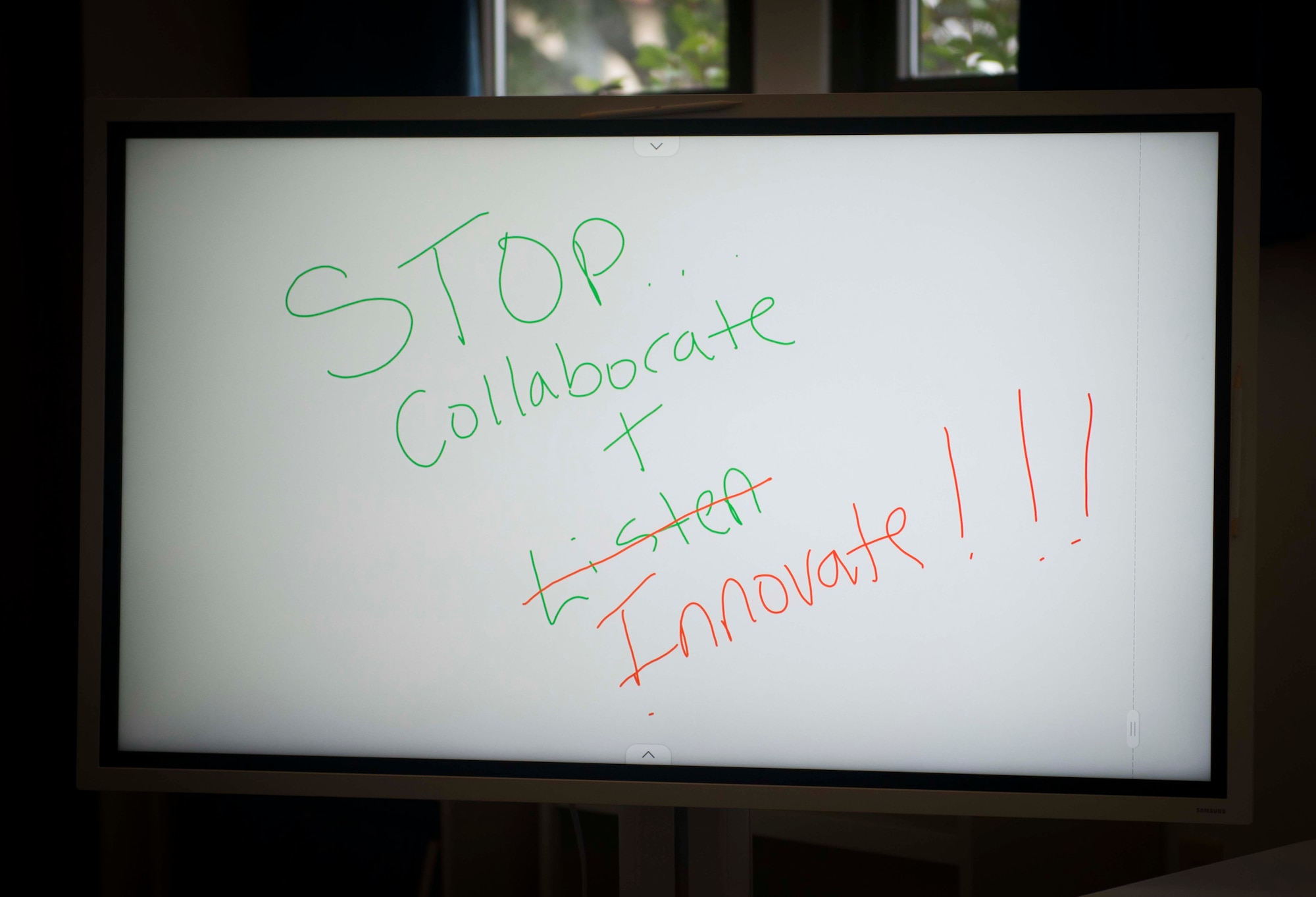 Photograph of a sign that reads, “Stop, collaborate and innovate” at AFPC’s inaugural Innovation Symposium