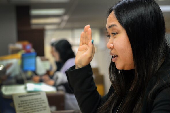 Jersouk Touy, Hanscom Air Force Base, Mass., Sexual Assault Prevention and Response Office program manager, signs the registry as an appointed member to the Governor’s Council to Address Sexual Assault and Domestic Violence at the Massachusetts State House in Boston Jan. 29. (U.S. Air Force photo by Lauren Russell)